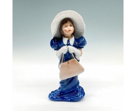 Figure of a little girl in an oversized grown up dress and wide brimmed hat. Item's full title: The Make-believe World of Chi