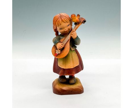 Hand carved figure of a little girl playing the lute with a bird chirping at her side. Hand painted item. Anri backstamp. Art