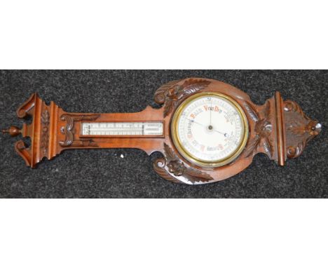 A mahogany cased Aneroid barometer with mercury thermometer fitted to trunk.