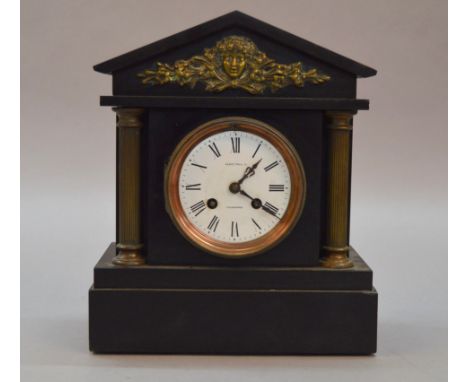 A black slate cased mantle clock, face marked "Alex Philip Edinburgh", movement marked "31452". 29cm tall.