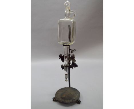 An Austrian iron and glass wine dispenser and stand. Decanter marked "Patent F. Steflitschek Wien".