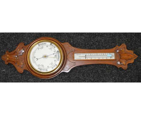 An oak cased Aneroid Barometer with thermometer. 