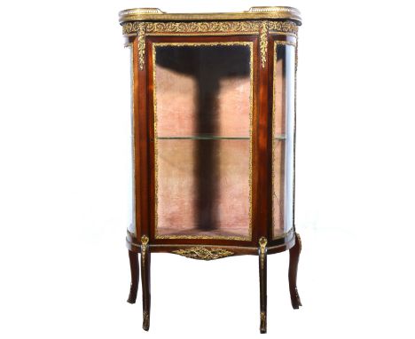 French mahogany vitrine, serpentine form, the top with pierced gallery, the door enclosing one shelf, cabriole legs, gilt met