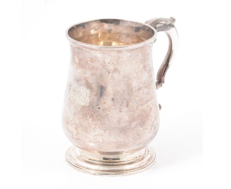 George III silver mug, possibly John Scofield, London 1774, baluster form, leaf capped scrolled handle, circular foot, engrav