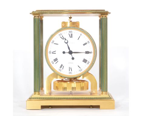 A Jaeger LeCoultre Atmos clock, brass case with fluted columns, bracket feet, glass panels, white circular dial, width 21cm, 