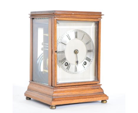 Walnut cased mantel clock, glazed panels, moulded plinth, brass bun feet, silvered dial with Roman numerals, Winterhalder &am