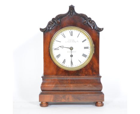 Victorian mahogany bracket clock, shaped top with carved edge, plinth base, bun feet, 14.5cm diameter painted dial with Roman