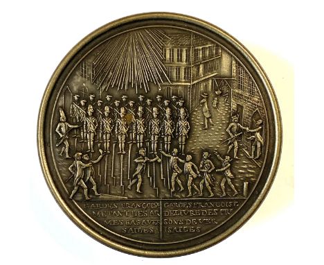 19th Century French metal and bois durci snuff box, circular form, the cast lid showing a scene of Guards at Arms and Prisone