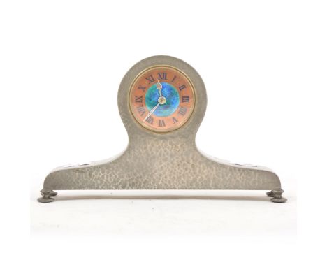An Arts and Crafts 'Tudric' pewter mantel clock, retailed by Liberty &amp; Co., circa 1900, the circular dial with enamelled 