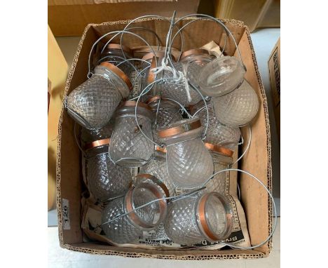 A quantity of moulded clear glass tea light holders with metal suspension loops **Lots must be paid for and collected within 
