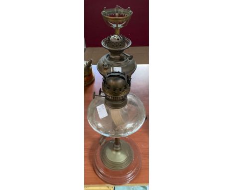 A Victorian faceted glass oil lamp supported on brass and glazed pottery stand; a brass and turned wood pedestal stand for an