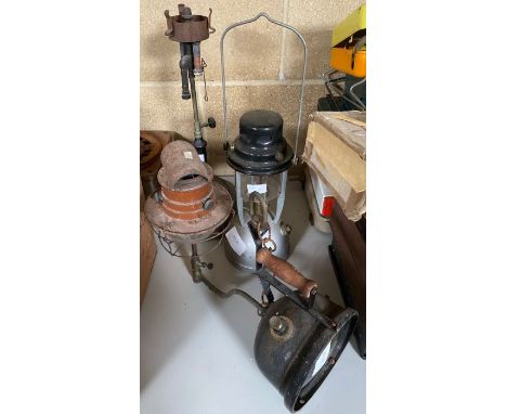 A Tilley "Hendon" portable and wall mounted lamp, with wooden handle and brown painted metal chimney, together with two other
