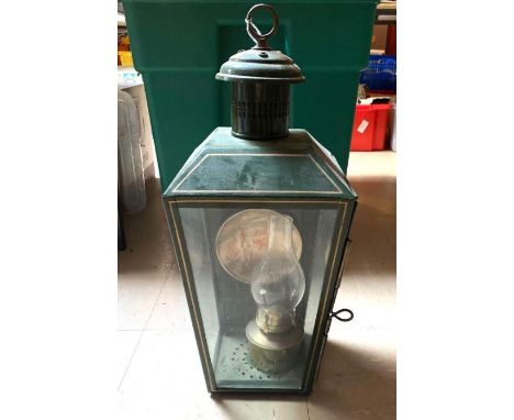 A pendant hall/entrance lantern with brass suspension loop, contains an oil lamp with reflector, re-painted, 54cms high max. 