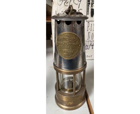 A "Protector" miners lamp with makers plate for Eccles Manchester, 23cms high **Lots must be paid for and collected within se
