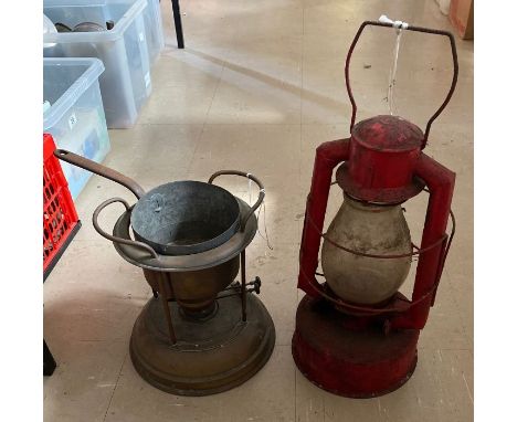 An early portable copper oil fired stove with copper pan; together with a large oil fired carrying lamp with red painted meta
