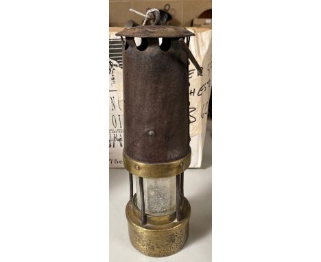 A brass and steel miners lamp with simple metal suspension hook, 29.5cms high **Lots must be paid for and collected within se