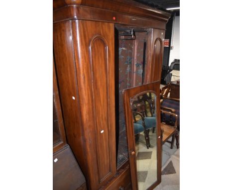 A Victorian mahogany mirror door wardrobe having drawer base