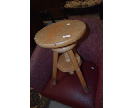 A vintage beech adjustable stool