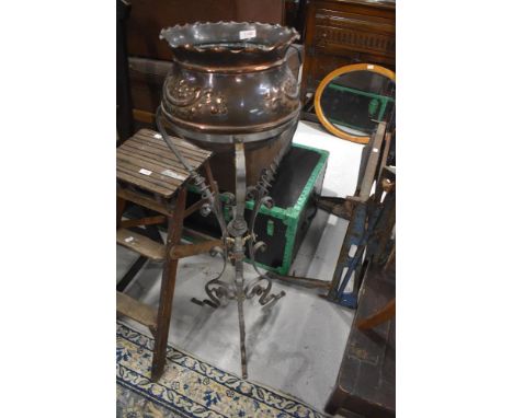 A 19th Century copper jardiniere on wrought metal frame
approx 101cm high, a few nominal age realted dings to copper planter.