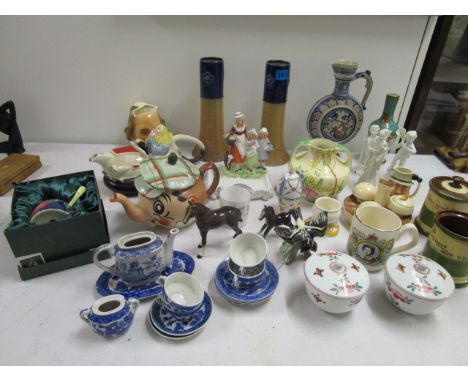 A quantity of ceramics to include a pair of Doulton stoneware vases, a Wade Andy Capp teapot, a Goebel bird, a Carlton ware c