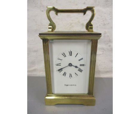 A Mappin and Webb brass cased carriage clock having a white enamel dial with Roman numerals, 6h