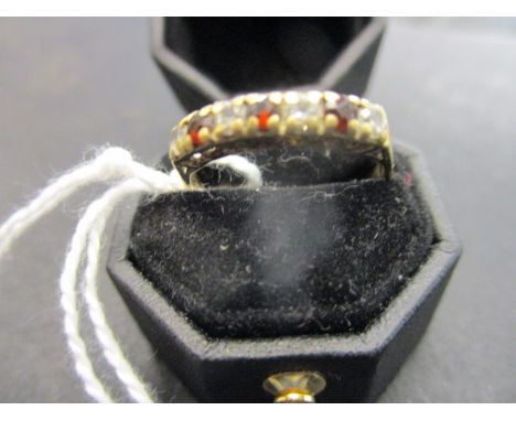 An 18ct gold, ruby and white stone set half-eternity ring