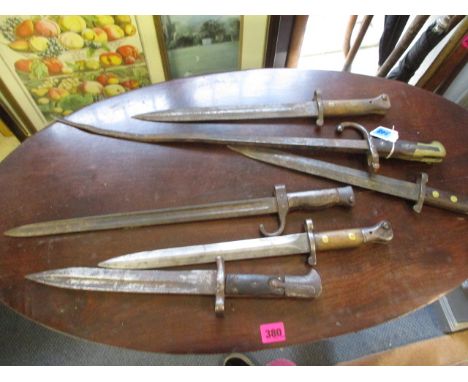 A group of six late 19th/early 20th century bayonets to include a Wilkinson, London military issue wooden handled bayonet