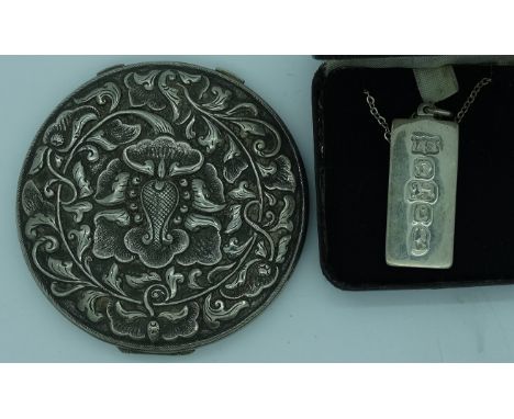 Silver ingot necklace + a powder compact  