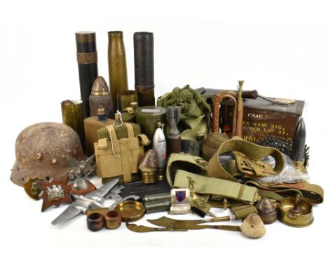A mixed group of militaria including WWI and later shell casings, a copper and brass bugle, Trench Art, a WWII relic helmet, 