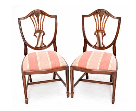 A set of six Hepplewhite style mahogany dining chairs, with shield shaped backs and drop in seats, on molded and tapered legs