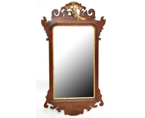 A George III style mahogany fret frame wall mirror, with pierced and gilt eagle surmount above a rectangular frame within a g