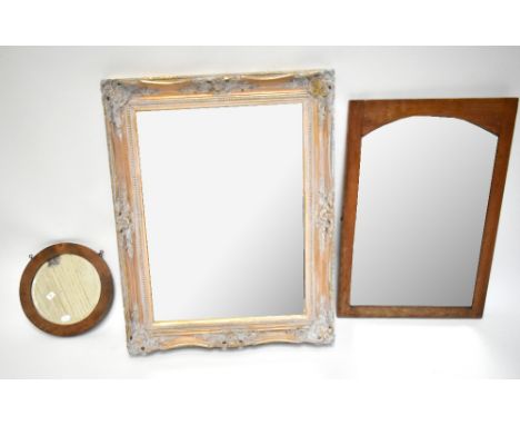 A gilt gesso framed mirror, 76 x 61cm, a smaller bevelled mirrored panel, 66 x 44.5cm, and a small circular mirror (3).Additi