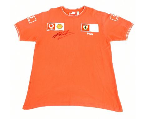 MICHAEL SCHUMACHER; a Fila Ferrari official team shirt with embroidered logos signed to front, size L. Additional Information