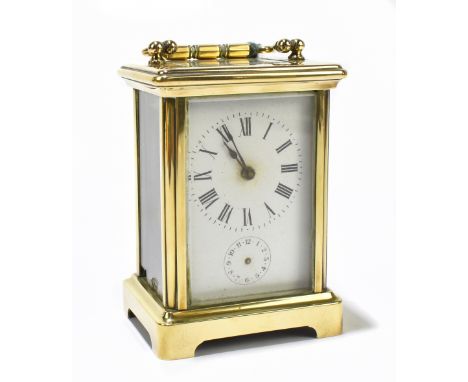 A late 19th century French brass cased carriage clock, the enamelled dial set with Roman numerals and subsidiary dial, height