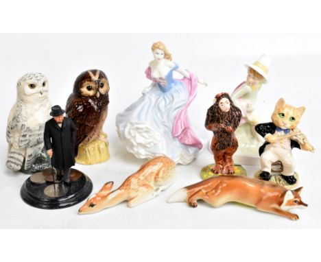 A group of Royal Doulton including 'The Cat and The Fiddle', no.507, 'Lion' from The Wizard of Oz, 'Tawny Owl' and 'Snowy Owl