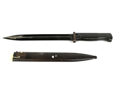 A WWII German Wehrmacht bayonet with fullered blackened blade, stamped to base ‘Elite-Daimant’ and numbered 5443b, the hilt w