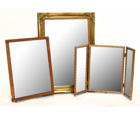 A gilt framed wall mirror with bevelled plate, 24.5 x 19cm, together with an oak framed mirror and a dressing table triptych 