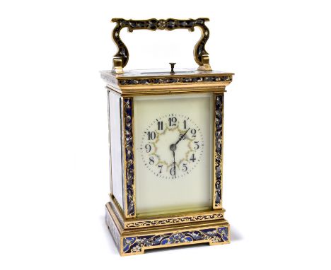An early 20th century French brass and champlevé enamel decorated repeating carriage clock with swing loop handle above recta