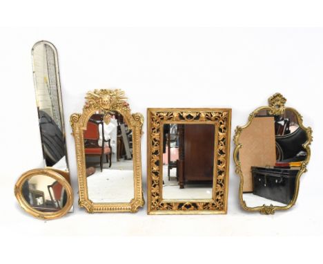 A Louis XIV style gilt wood and gesso wall mirror, with mask and sun burst crest above a shaped plate and within a moulded fr