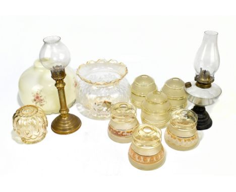 An early 20th century oil lamp with moulded glass reservoir, height including chimney 43cm, together with a brass candlestick