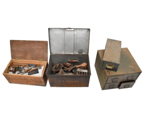 A black painted tin chest containing an assortment of tools including braces, blow lamp, together with a further tin filing c