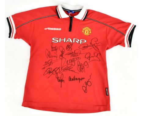 MANCHESTER UNITED TREBLE WINNERS; an Umbro 1998-99 season child’s home shirt signed by Yorke, Solskjaer, Scholes, Sheringham,