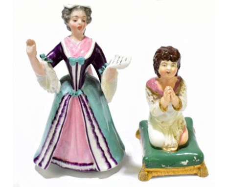 DERBY; a 19th century figure representing a kneeling girl praying, raised on a shaped green cushion, height 9cm, together wit