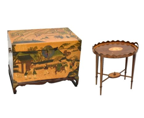 A Chinese reproduction twin handled trunk on stand, with printed decoration throughout depicting figures in mountainous lands