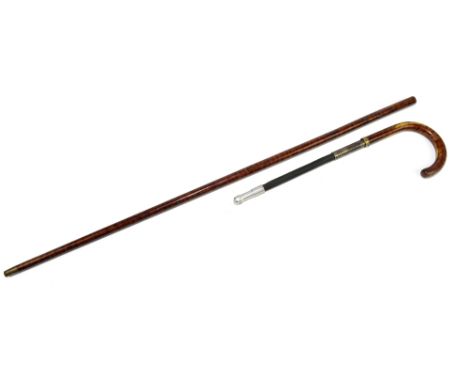 A novelty painted metal riding crop in the form of a walking stick, the handle lifts to release a material and metal crop, ov