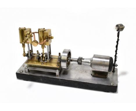 A contemporary scratch built steam engine of rectangular form, raised on a black painted plinth base, length 30cm.