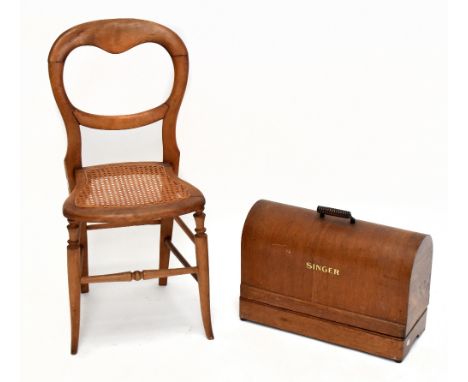 SINGER; a oak cased manual sewing machine, together with a late Victorian cane seated balloon back bedroom chair (2).