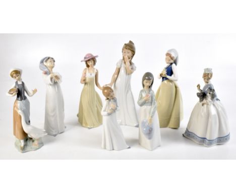 LLADRO; two figures, one of a young maiden and a goose, the other of a boy sleepwalking, together with six Nao figures, heigh
