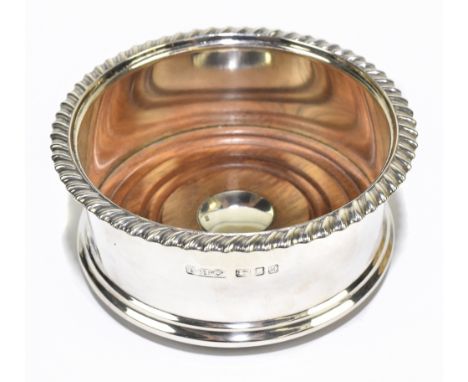 G-H &amp; CO; an Elizabeth II hallmarked silver bottle coaster with gadrooned rim, London 1986, diameter 11cm.Additional Info
