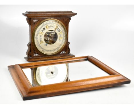 A Victorian carved oak aneroid barometer, 28cm high, with a walnut rectangular wall mirror (2)